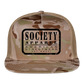 society essentials • black society patch trucker hat - multicam\tan